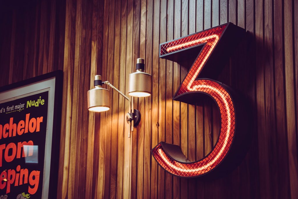 A number three hanging on a wall.
